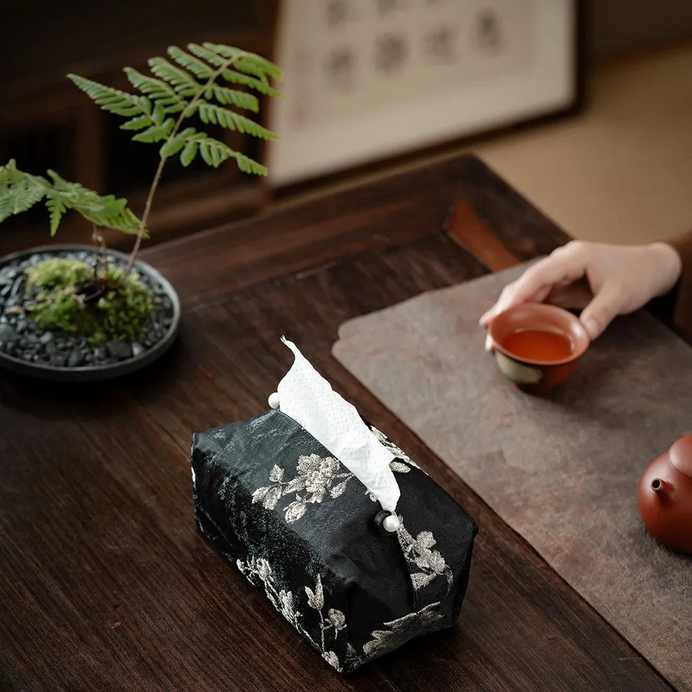 White embroidered Chinese brocade fabric tissue box with optional pearl buckle, shown on a table.