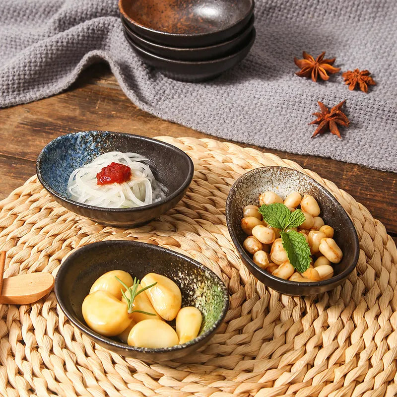 Oval Japanese ceramic sauce dipping bowl on a table, showing an example pattern option.