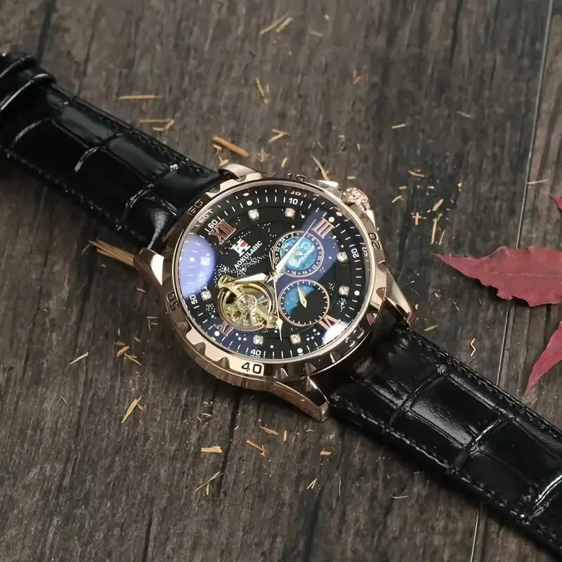 Men's black and rose gold skeleton automatic watch with leather strap on wrist