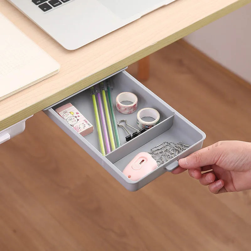 White plastic adhesive under-table storage drawer with covered lid and internal grid compartments