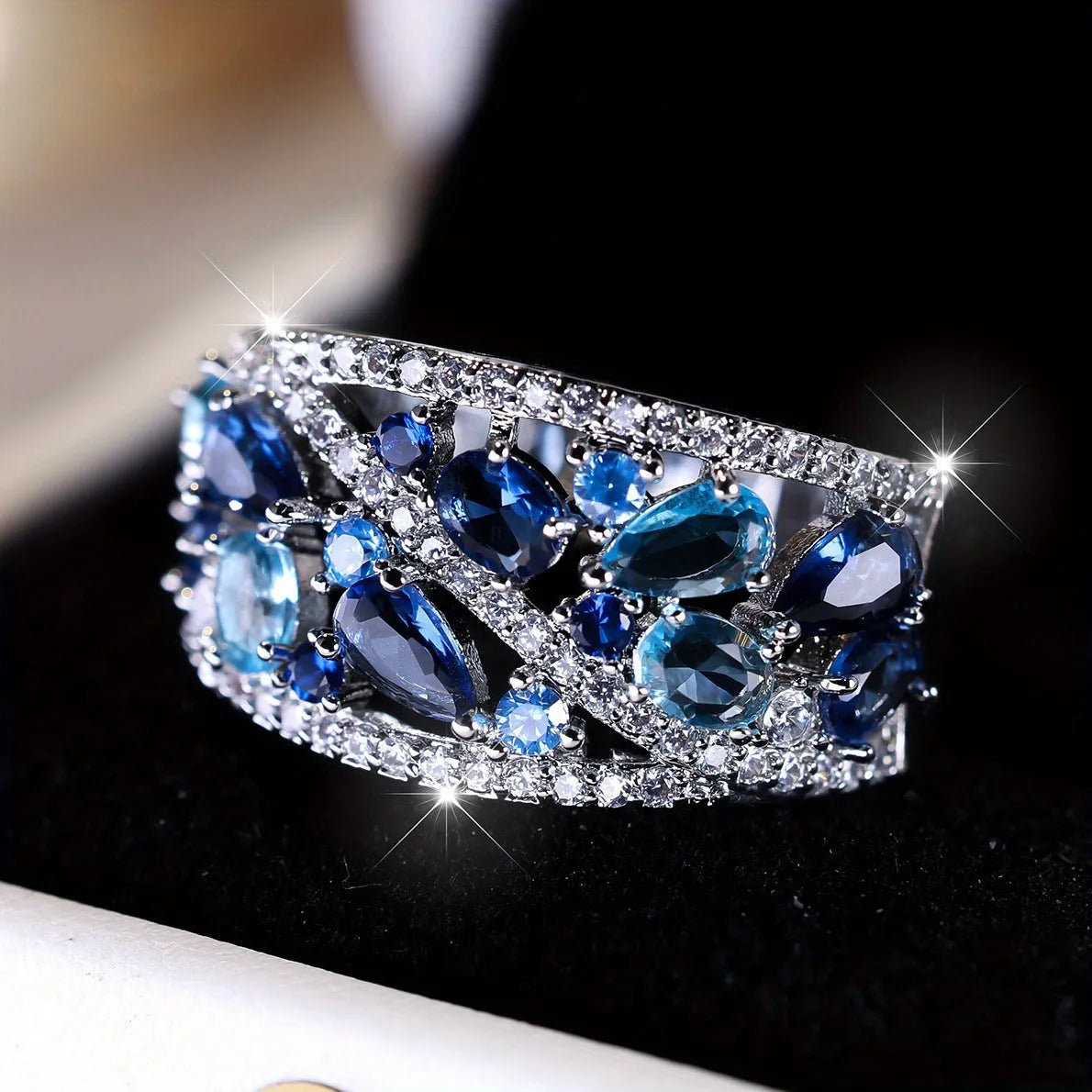 Women's copper hollow round fashion ring in gold or platinum with white or blue accent, shown on a hand.