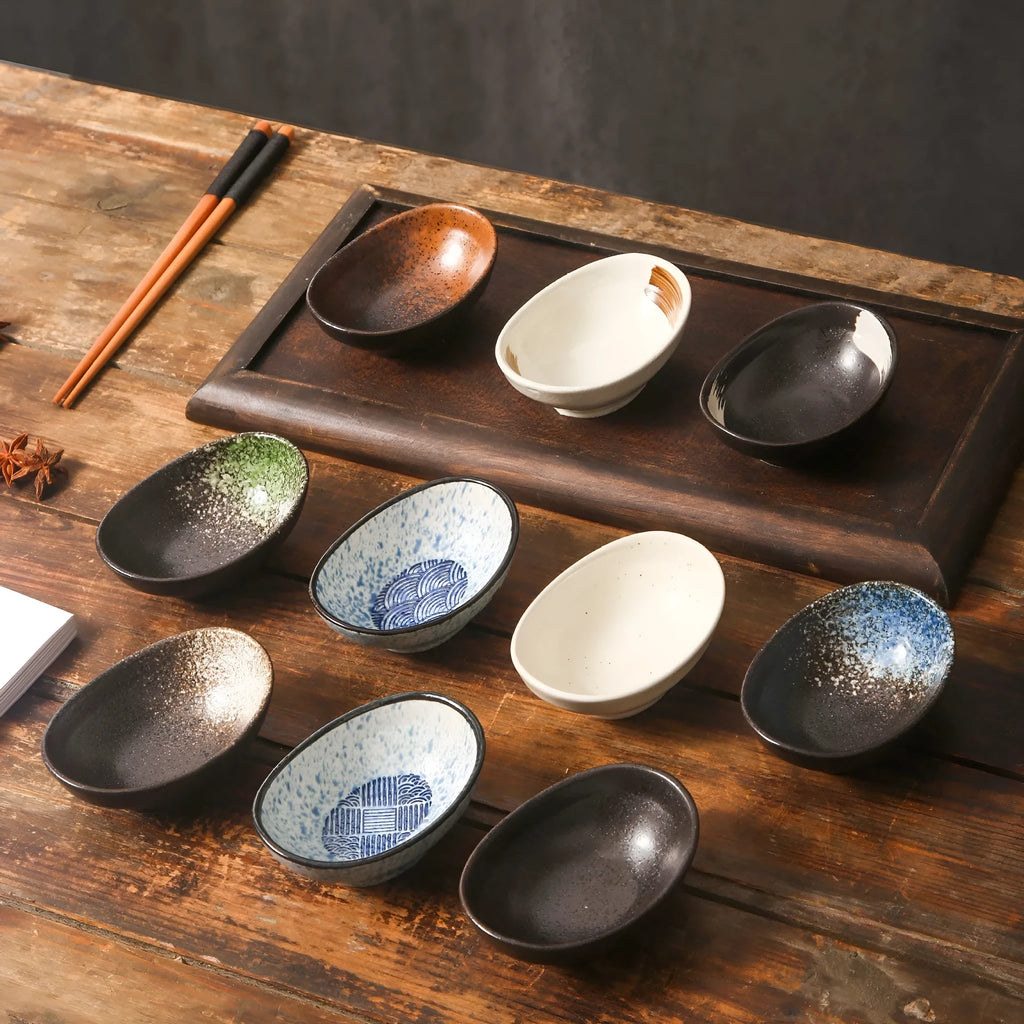 Oval Japanese ceramic sauce dipping bowl on a table, showing an example pattern option.