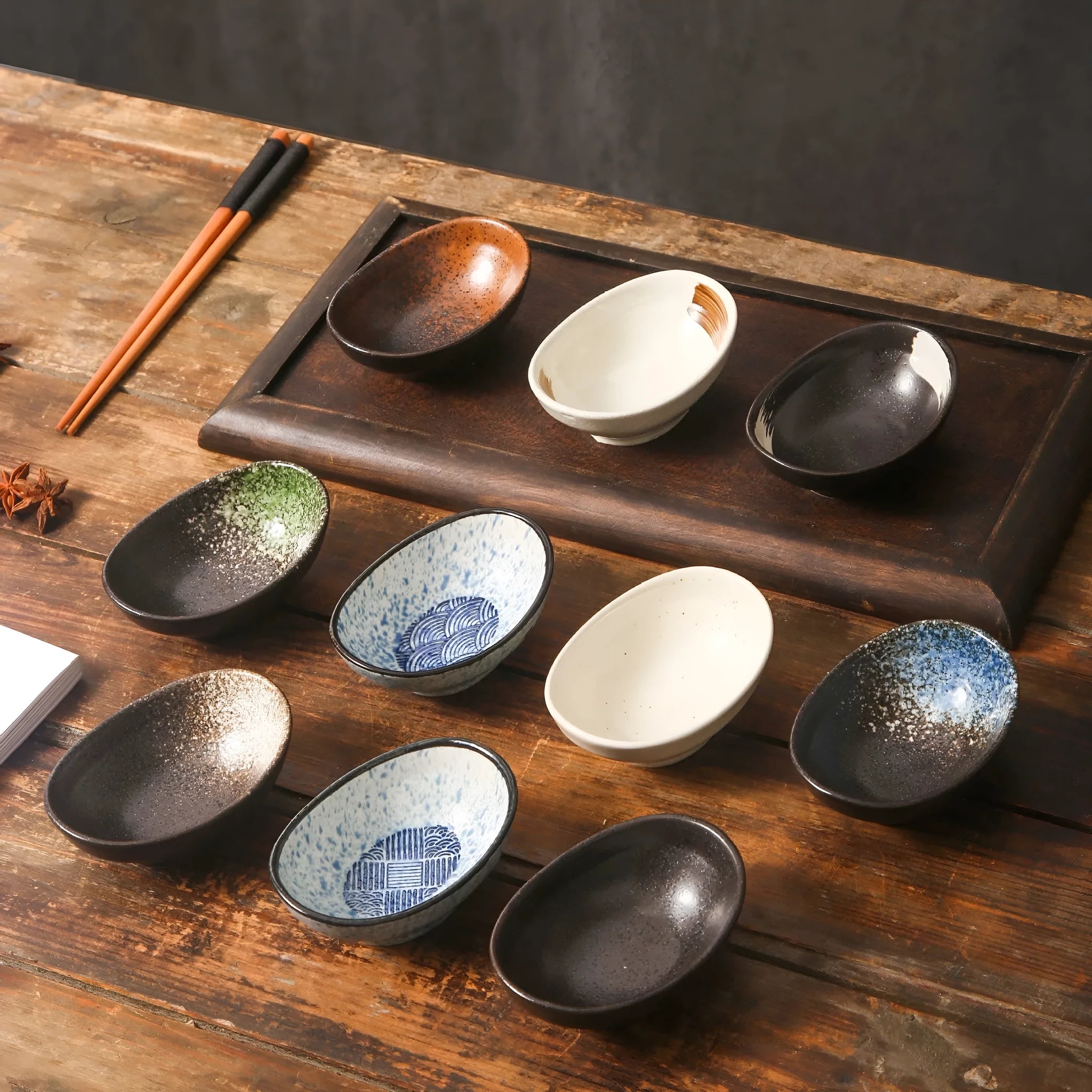 Oval Japanese ceramic sauce dipping bowl on a table, showing an example pattern option.