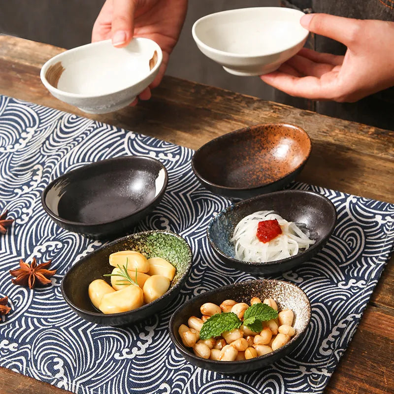 Oval Japanese ceramic sauce dipping bowl on a table, showing an example pattern option.