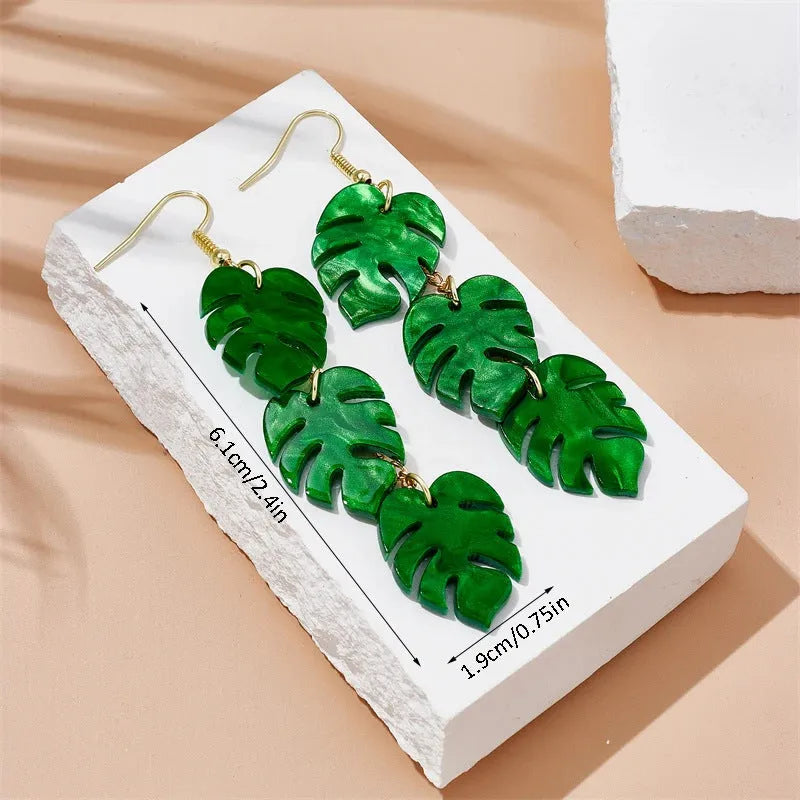 Women's alloy drop earrings with red and green acrylic jackfruit and coconut charms on a white background.