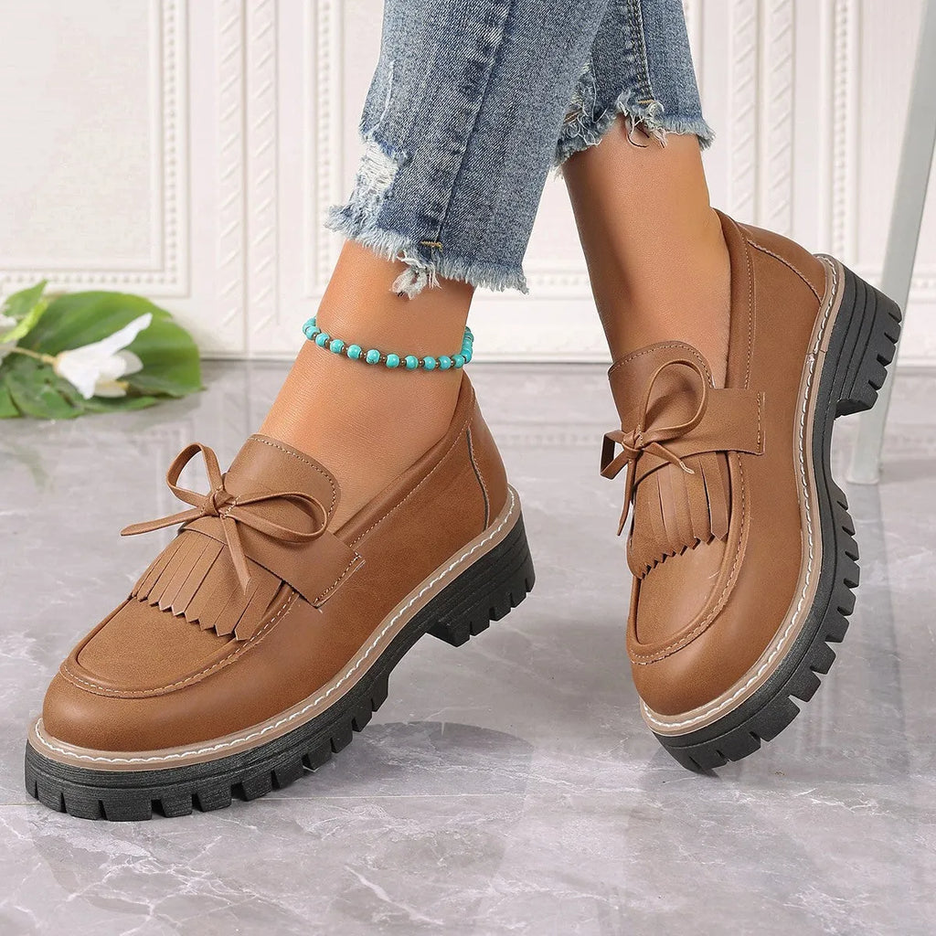 Black plus size women's loafers with tassel decoration, bowknot detail, and chunky heel
