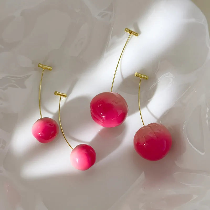 A pair of colourful acrylic peach-shaped stud earrings on a copper post, shown in small and large size options.