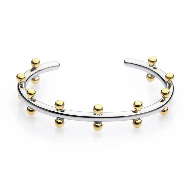 Stainless steel C-shaped bracelet with textured rivet and bean bead design in gold colour.