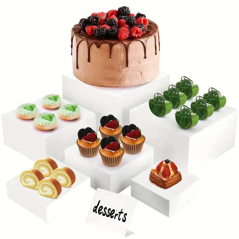 White plastic modular cube set assembled as a tiered desktop dessert display stand.