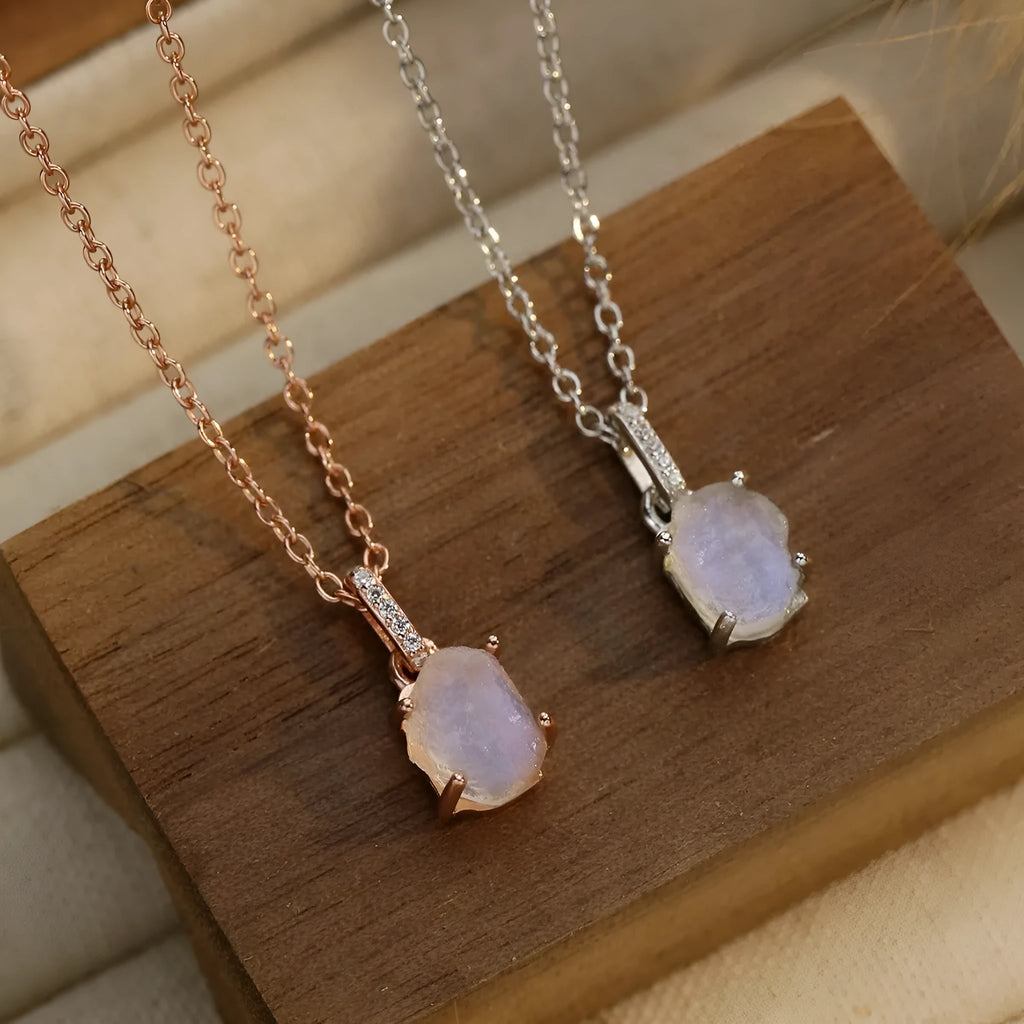 Geometric quadrilateral crystal pendant on sterling silver curb chain necklace with rose gold or platinum plating options.