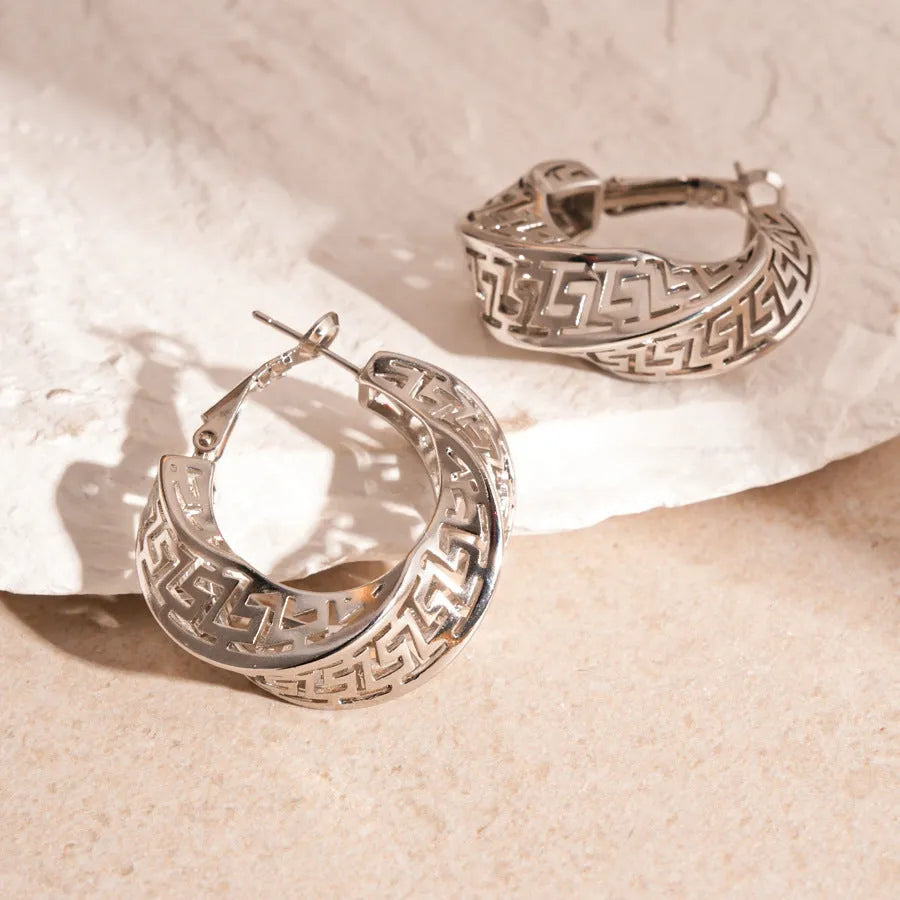 Geometric women's hollow stud earrings in gold or silver with exaggerated twisted round design