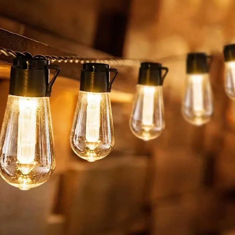 Retro solar outdoor string lights with infusion bottle shape bulbs in garden setting