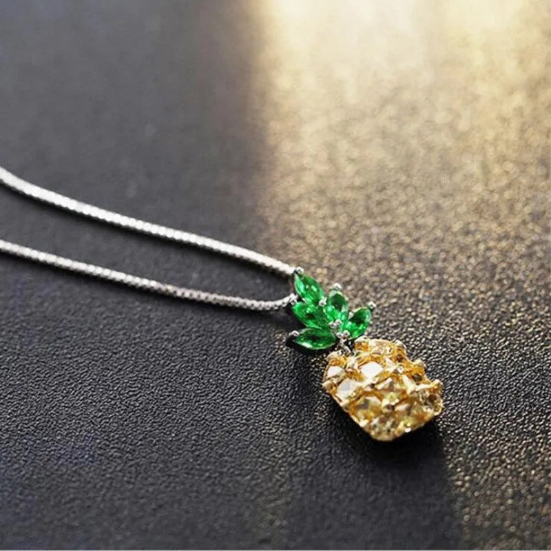 Silver geometric pineapple pendant necklace with diamond details on a model.