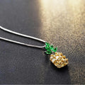 Silver geometric pineapple pendant necklace with diamond details on a model.