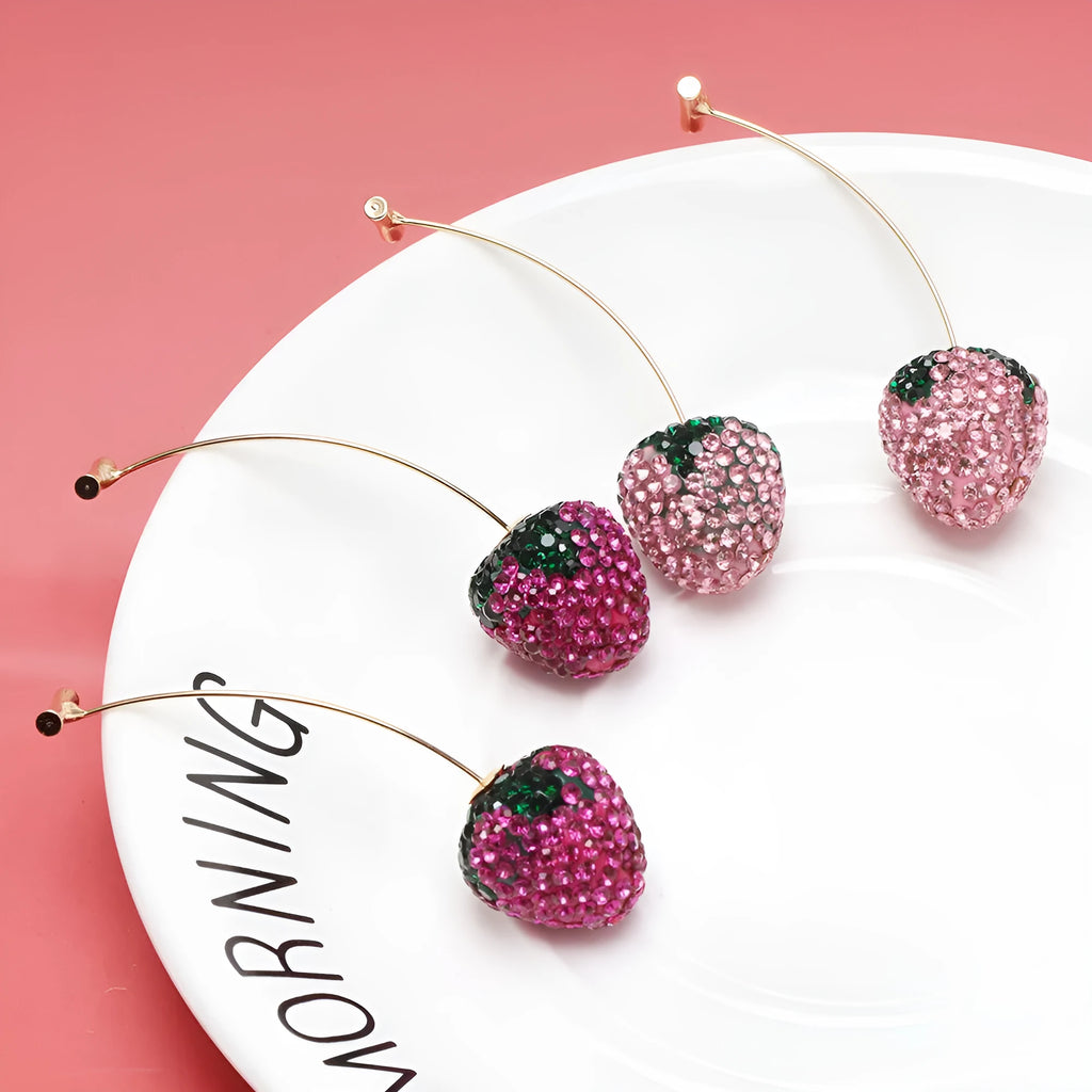 Geometric zinc alloy women's earrings with a red strawberry charm on a white background.