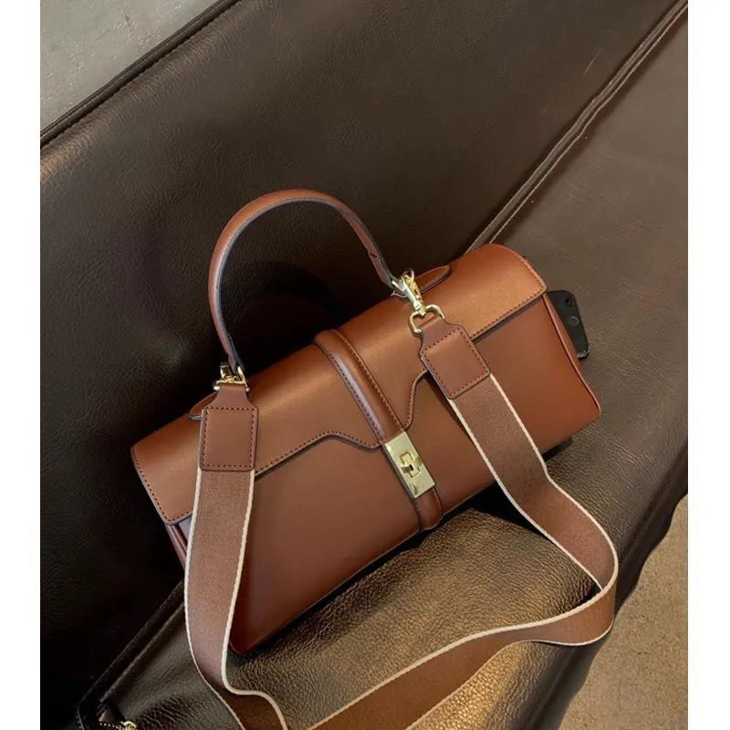 Women's genuine cowhide messenger bag in cylindrical shape with internal organisers