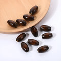 Oval wooden bead with M-shaped raised texture in dark coffee colour, showing 25mm dimensions