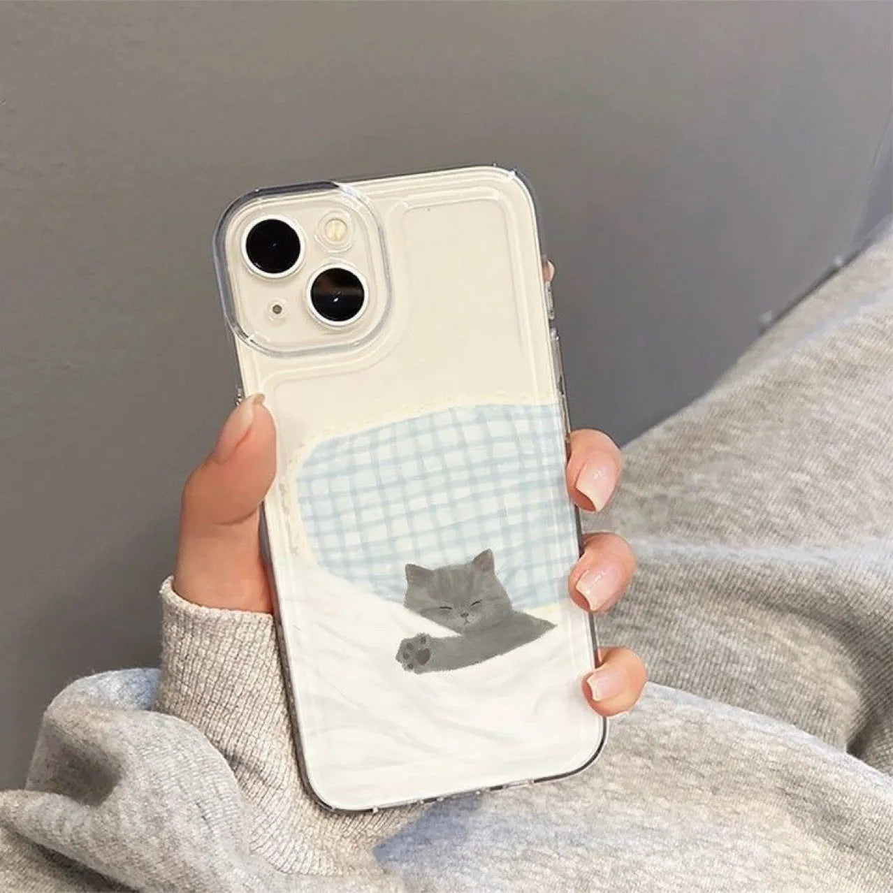 Transparent Apple iPhone case showing a sleeping cat pattern design on a clear TPU background.