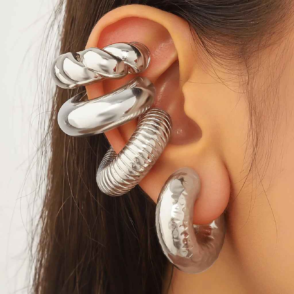 Geometric ear clip set in gold and silver colours for non-pierced wear with exaggerated design