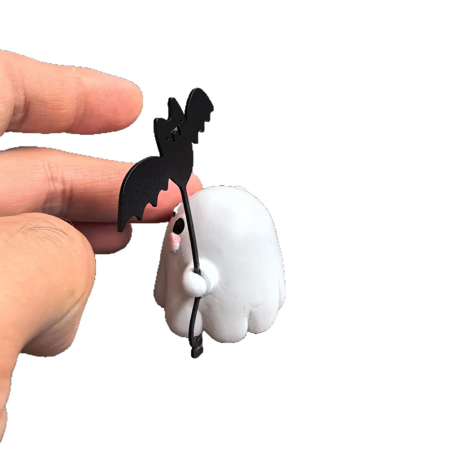 Small resin statue of a ghost walking a dog, a Halloween decoration.