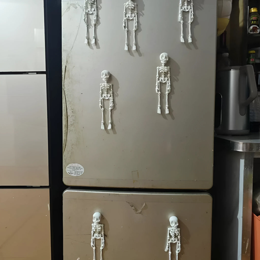 3D printed white skull refrigerator magnet ornament, 18cm tall, on a fridge door.