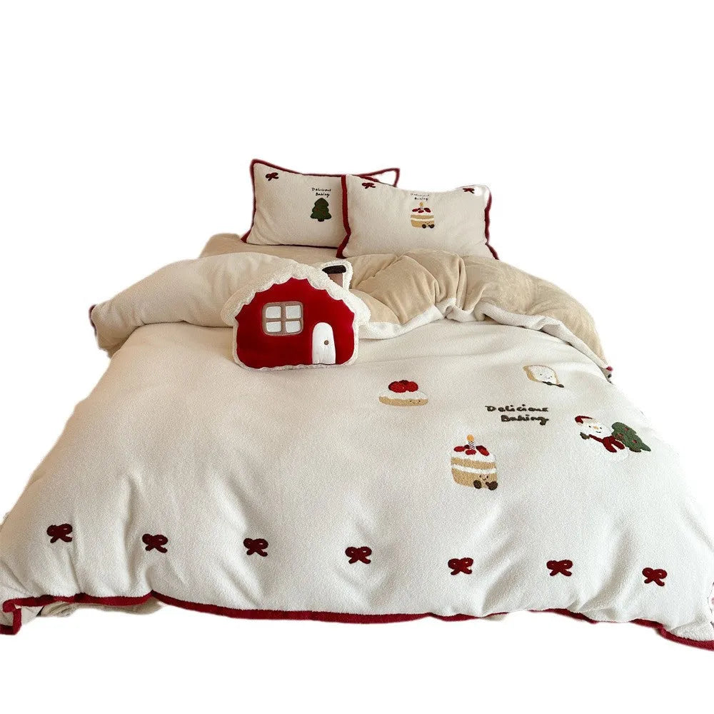 Girl's winter cartoon print bedding four-piece set with bed sheet, duvet cover, and pillowcases on a bed.