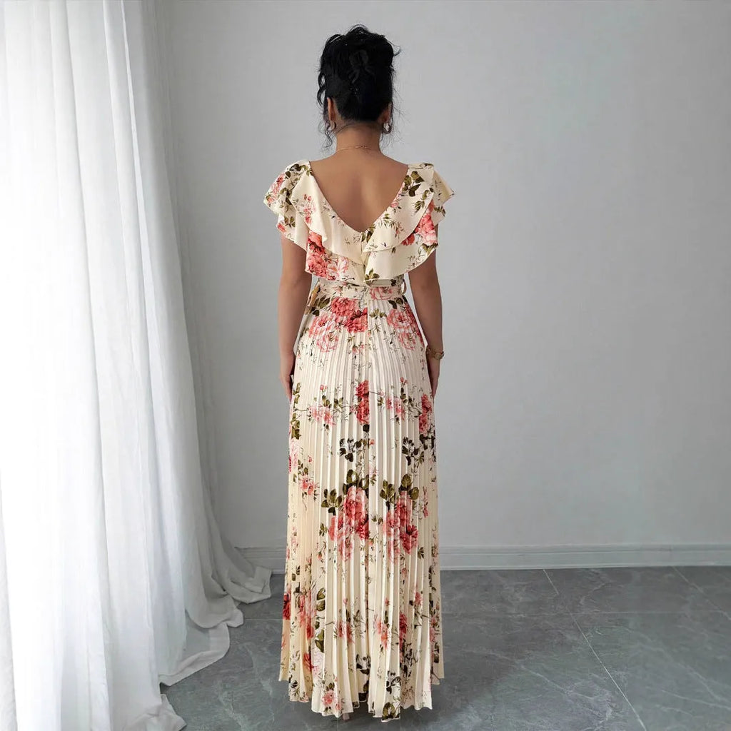 Apricot coloured floral print V-neck dress with ruffled sleeves and a pleated swing skirt.