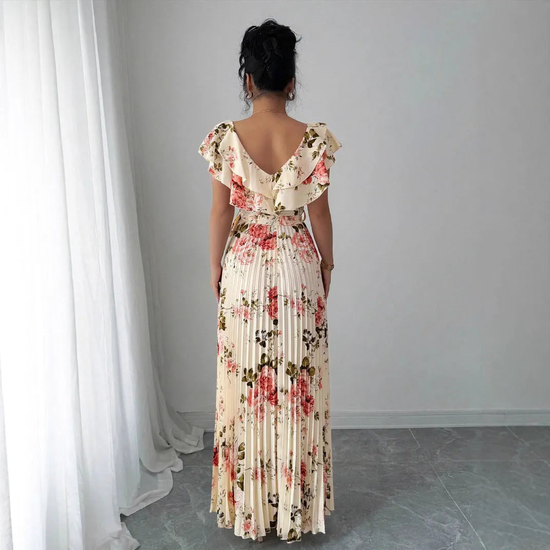 Apricot coloured floral print V-neck dress with ruffled sleeves and a pleated swing skirt.