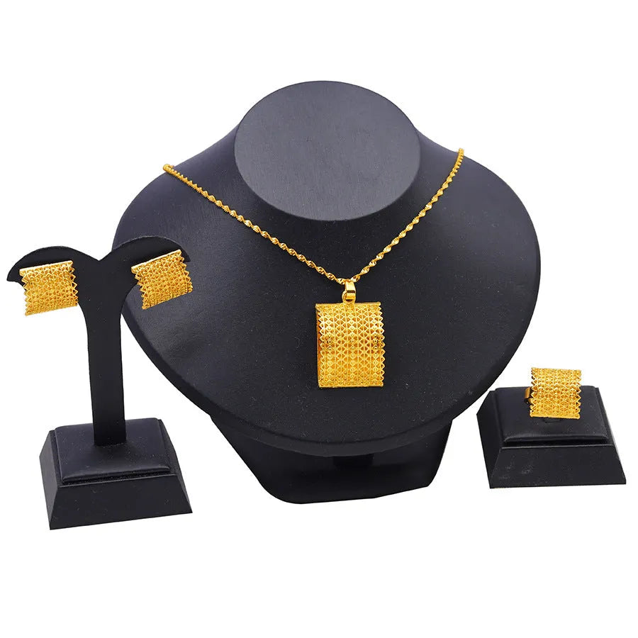 Gold tone bridal jewellery set with necklace, earrings and ring on display