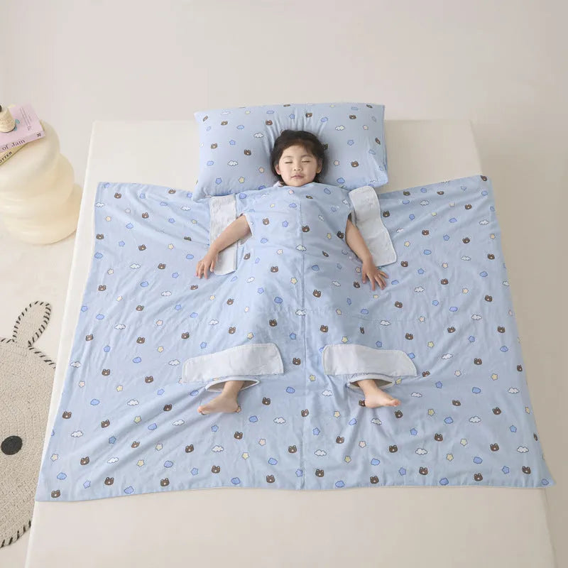 Patterned anti-kick sleeping bag blanket laid flat on a bed, showing its quilted texture.