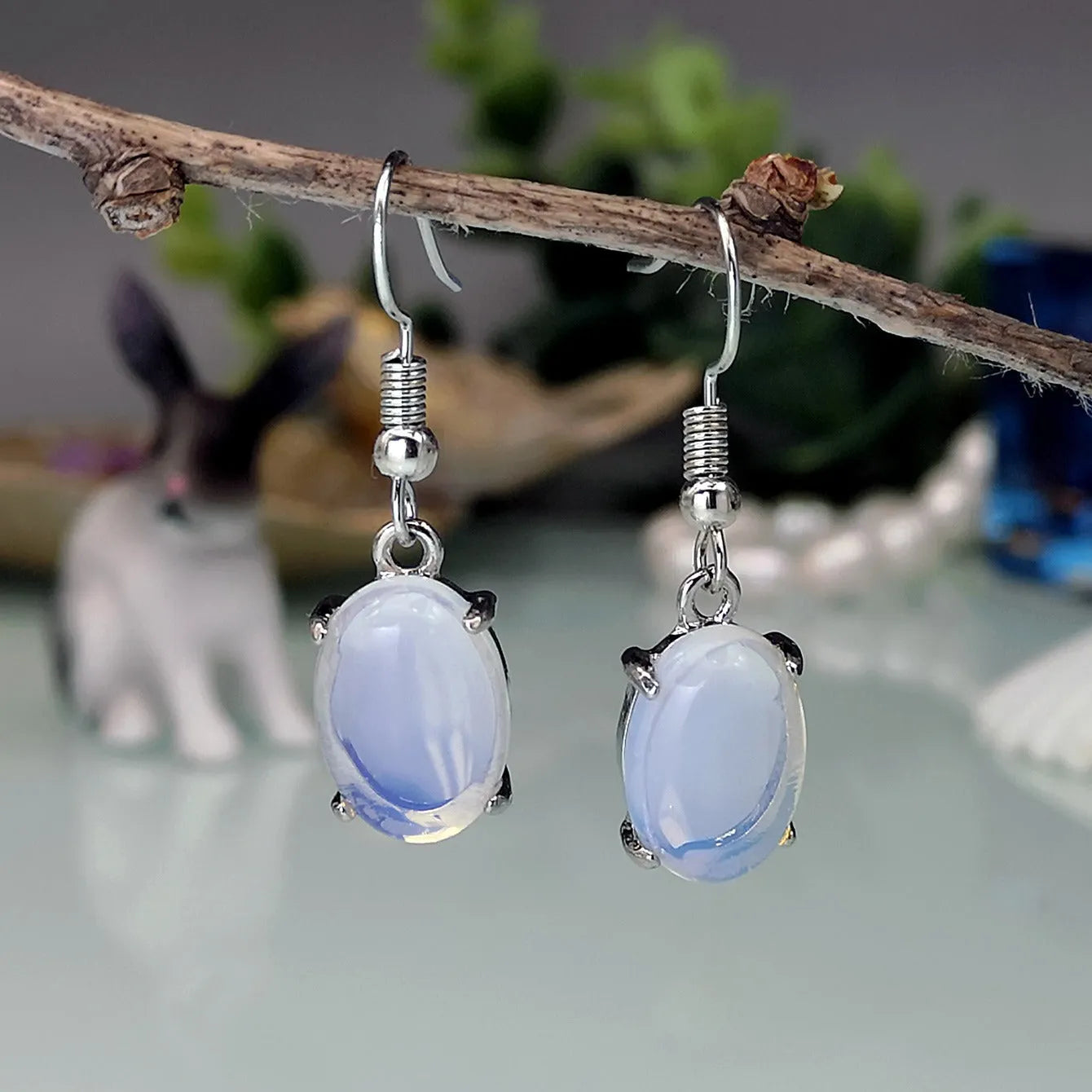 Moonlight white opal drop earrings with retro cross detail and electroplated finish