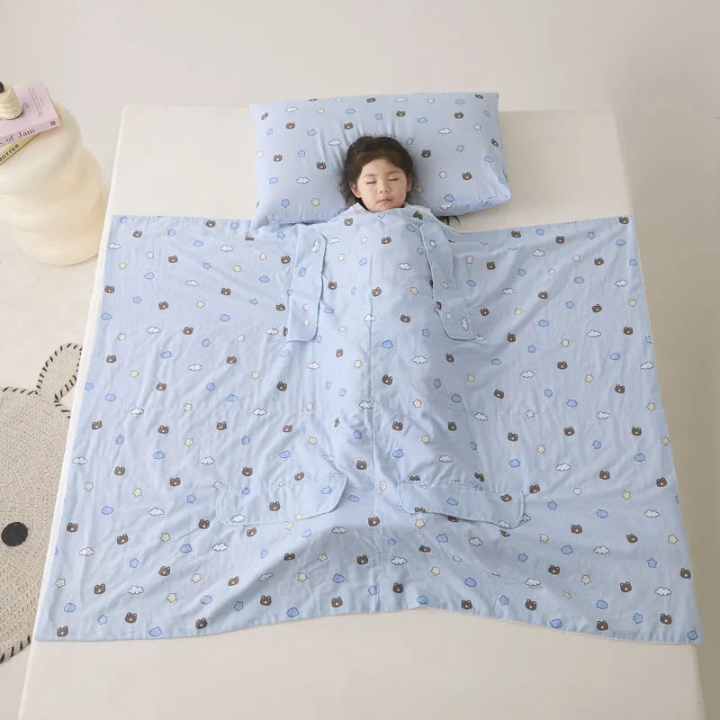 Patterned anti-kick sleeping bag blanket laid flat on a bed, showing its quilted texture.