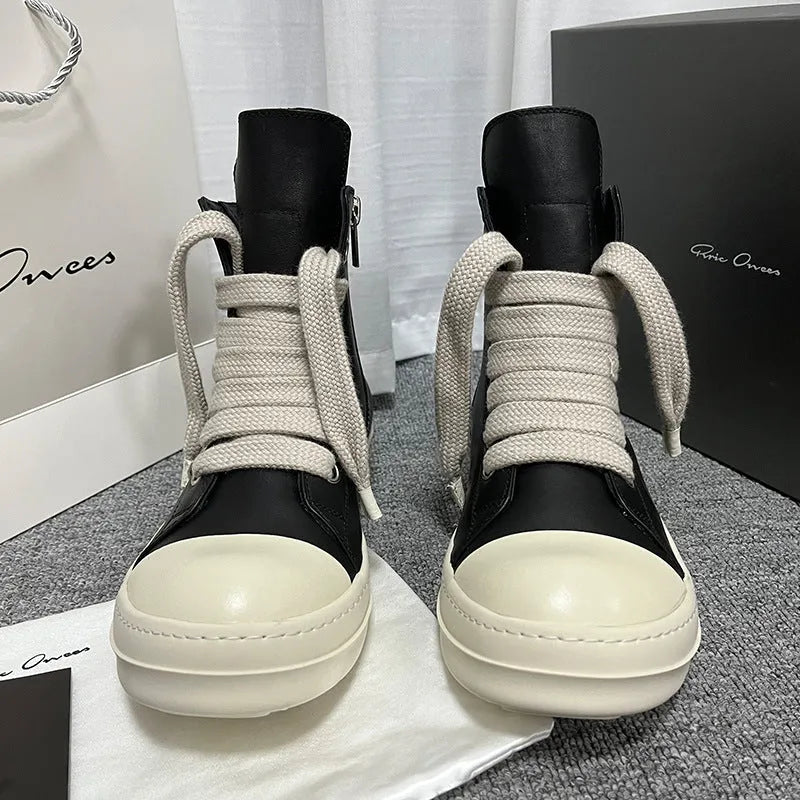 Black high-top leather sneaker boots with a side zipper and a thick rubber platform sole.