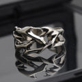 Copper men's ring with geometric thorn flower design and adjustable opening.