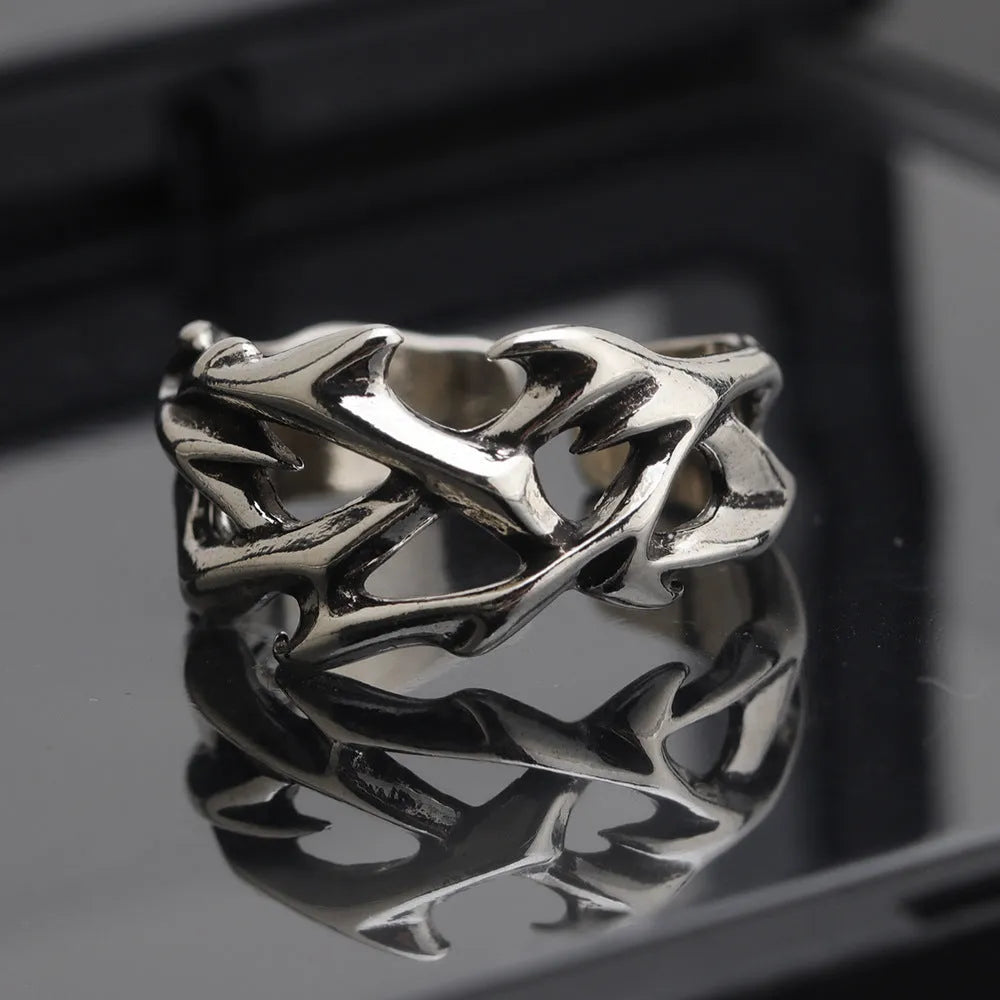Copper men's ring with geometric thorn flower design and adjustable opening.