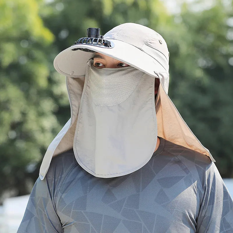 Man wearing a khaki sun hat with a built-in USB-rechargeable fan for face and neck protection.