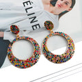 Colourful cartoon-style metal pendant earrings with a large round base and diamond shape for women.