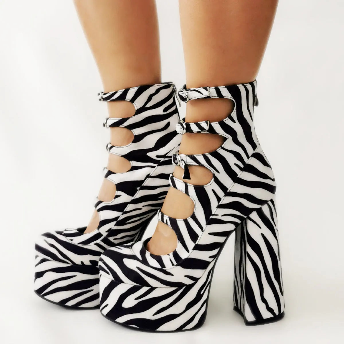 Black patent leather women's platform high heels with a thick heel and a serpentine belt ankle buckle.