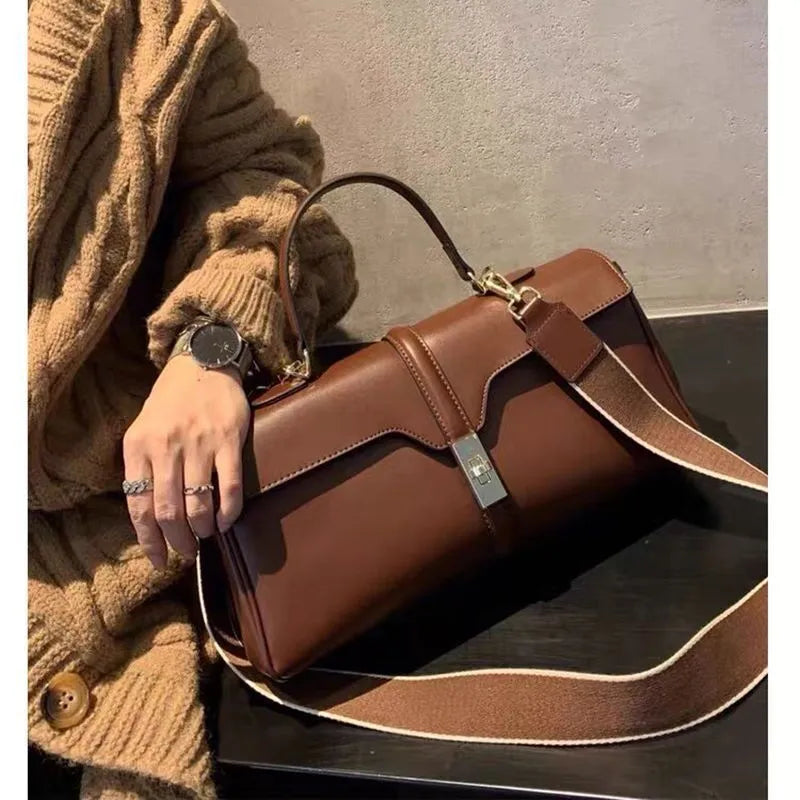 Women's genuine cowhide messenger bag in cylindrical shape with internal organisers