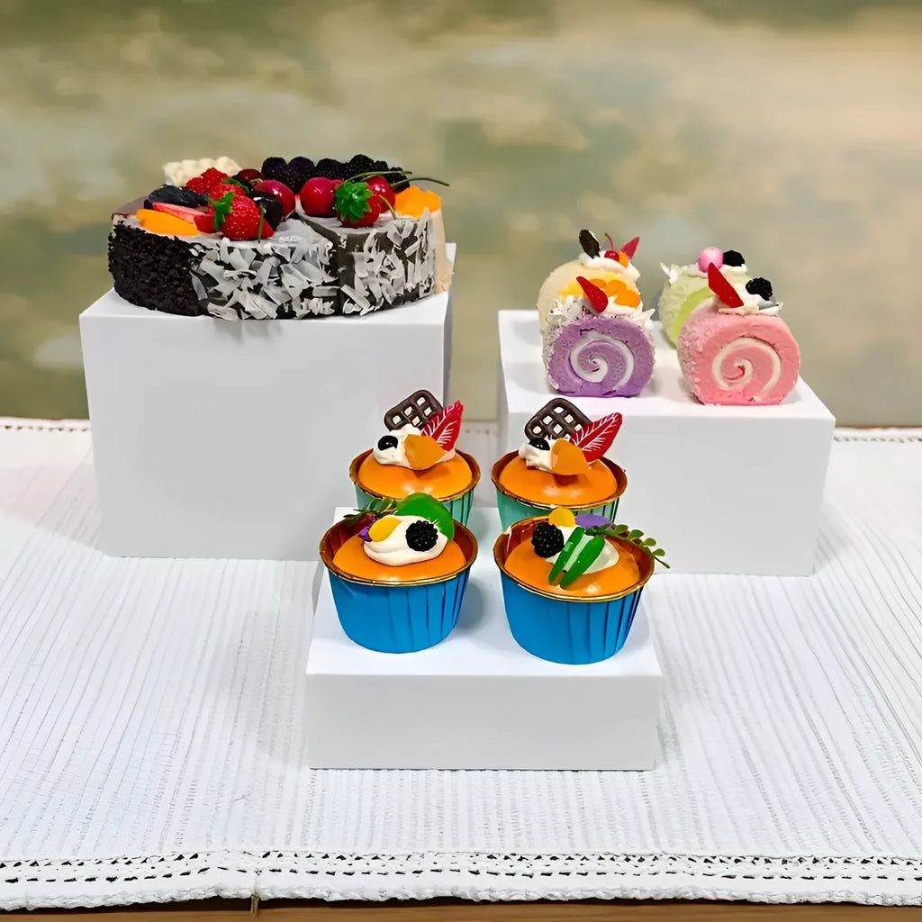 White plastic modular cube set assembled as a tiered desktop dessert display stand.