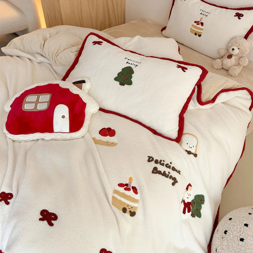 Girl's winter cartoon print bedding four-piece set with bed sheet, duvet cover, and pillowcases on a bed.