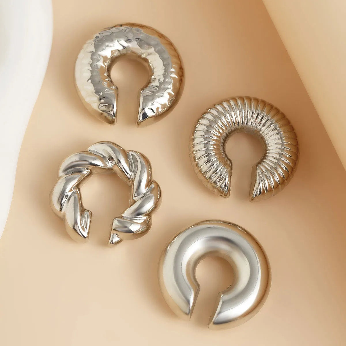 Geometric ear clip set in gold and silver colours for non-pierced wear with exaggerated design