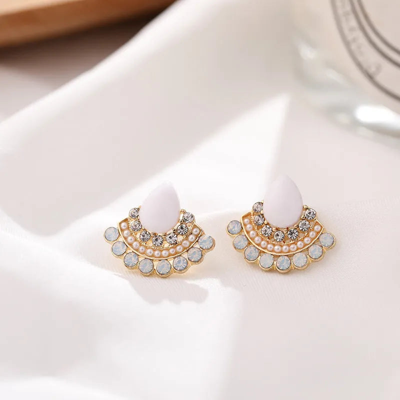Women's retro fan-shaped silver stud earrings with rhinestones on a geometric alloy design.