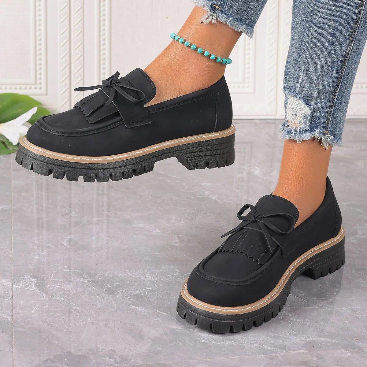 Black plus size women's loafers with tassel decoration, bowknot detail, and chunky heel