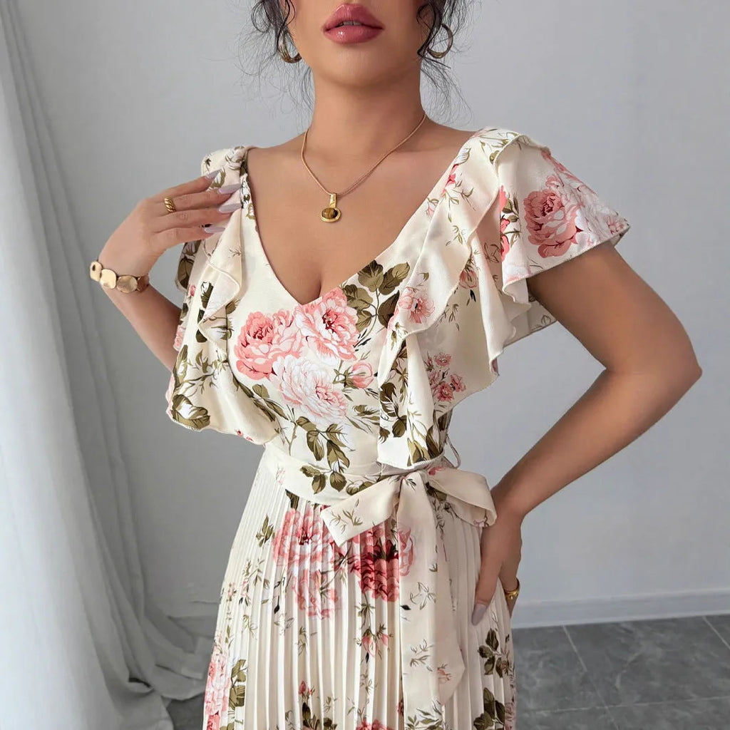 Apricot coloured floral print V-neck dress with ruffled sleeves and a pleated swing skirt.