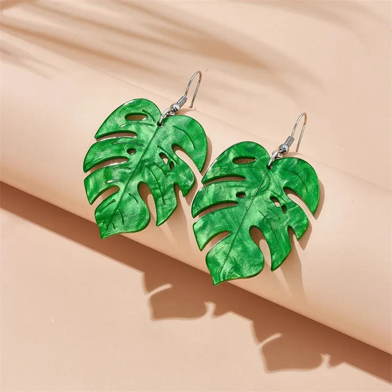 Women's alloy drop earrings with red and green acrylic jackfruit and coconut charms on a white background.