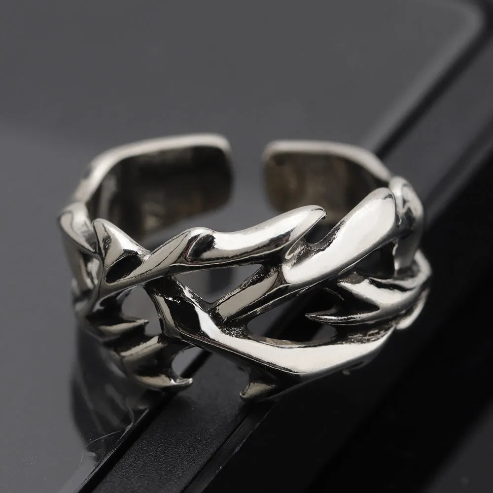 Copper men's ring with geometric thorn flower design and adjustable opening.