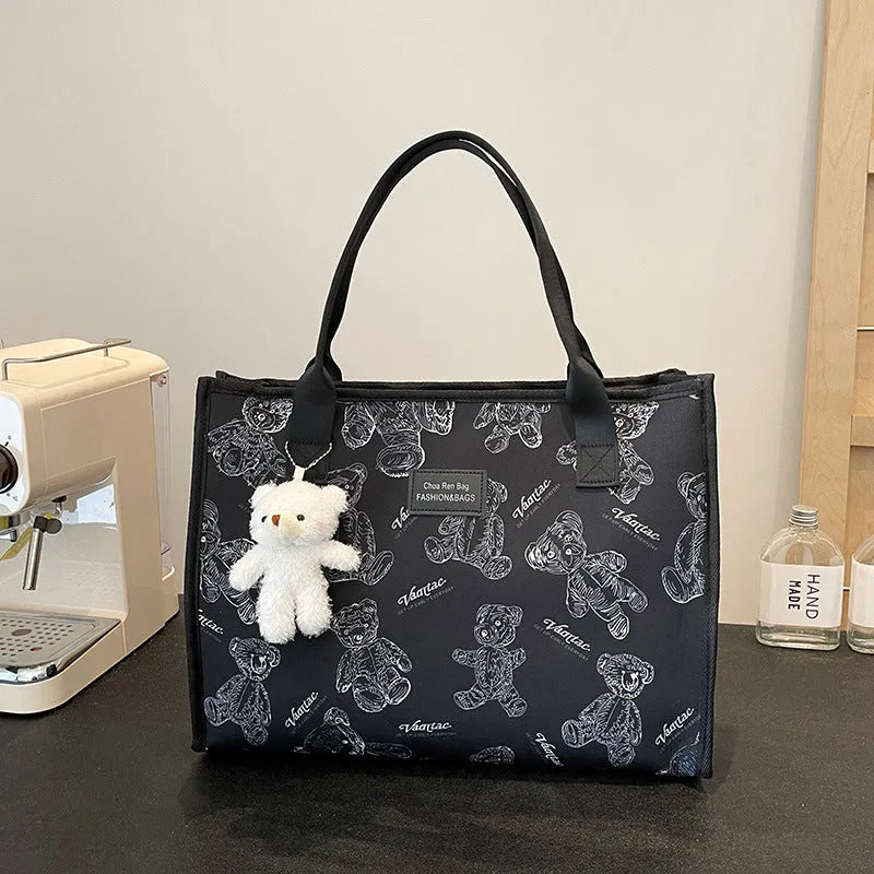 Women's black and white printed canvas tote bag showing rhombus pattern and sandwich pocket.
