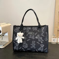 Women's black and white printed canvas tote bag showing rhombus pattern and sandwich pocket.