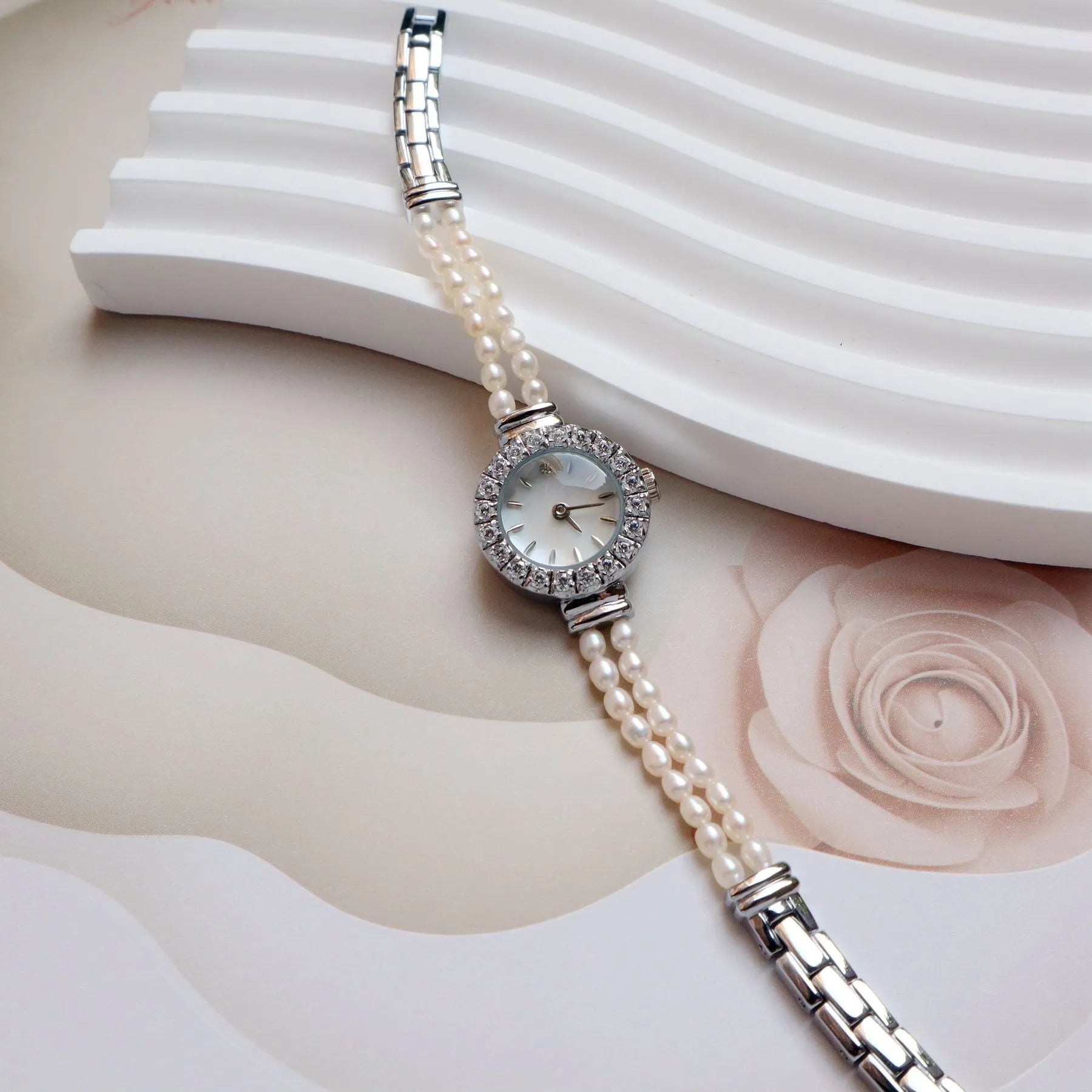 Light gold women's bracelet watch with freshwater pearls, round dial, and stainless steel strap